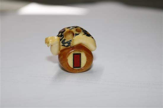 A Japanese ivory inlaid figurative netsuke